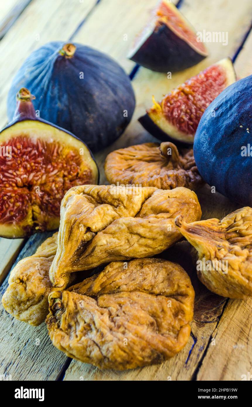 fresh and dried figs on a wooden table Stock Photo