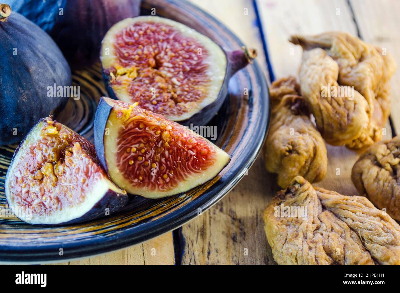 fresh and dried figs on a wooden table Stock Photo