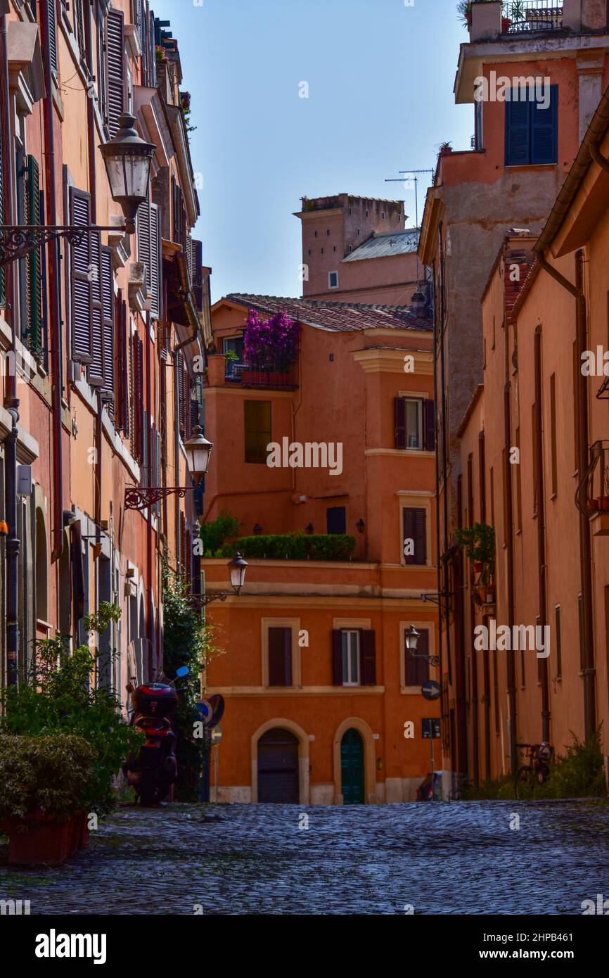 Vertical of a narrow empty street between old buildings in Rome, Italy ...