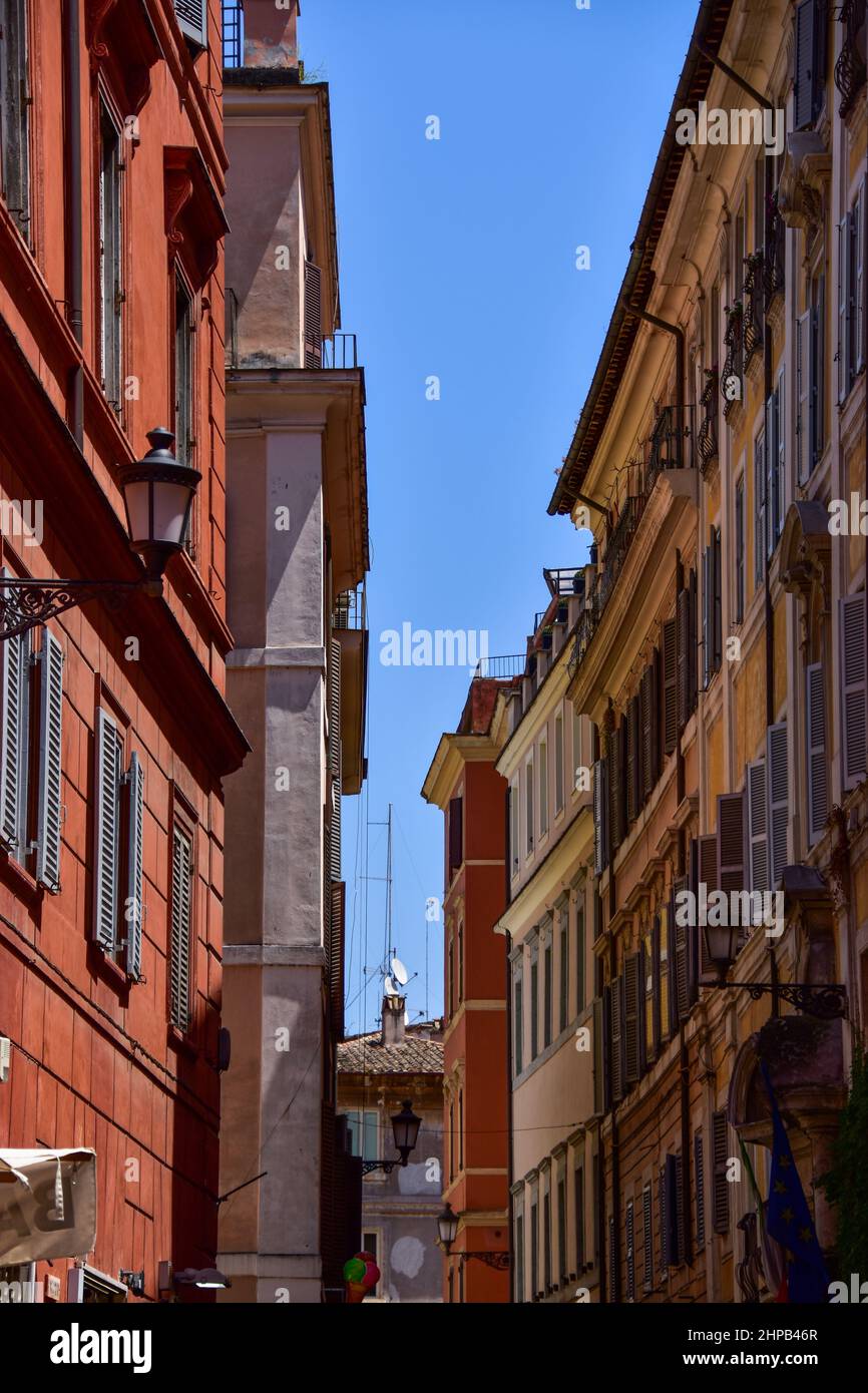 Vertical of a narrow empty street between old buildings in Rome, Italy ...