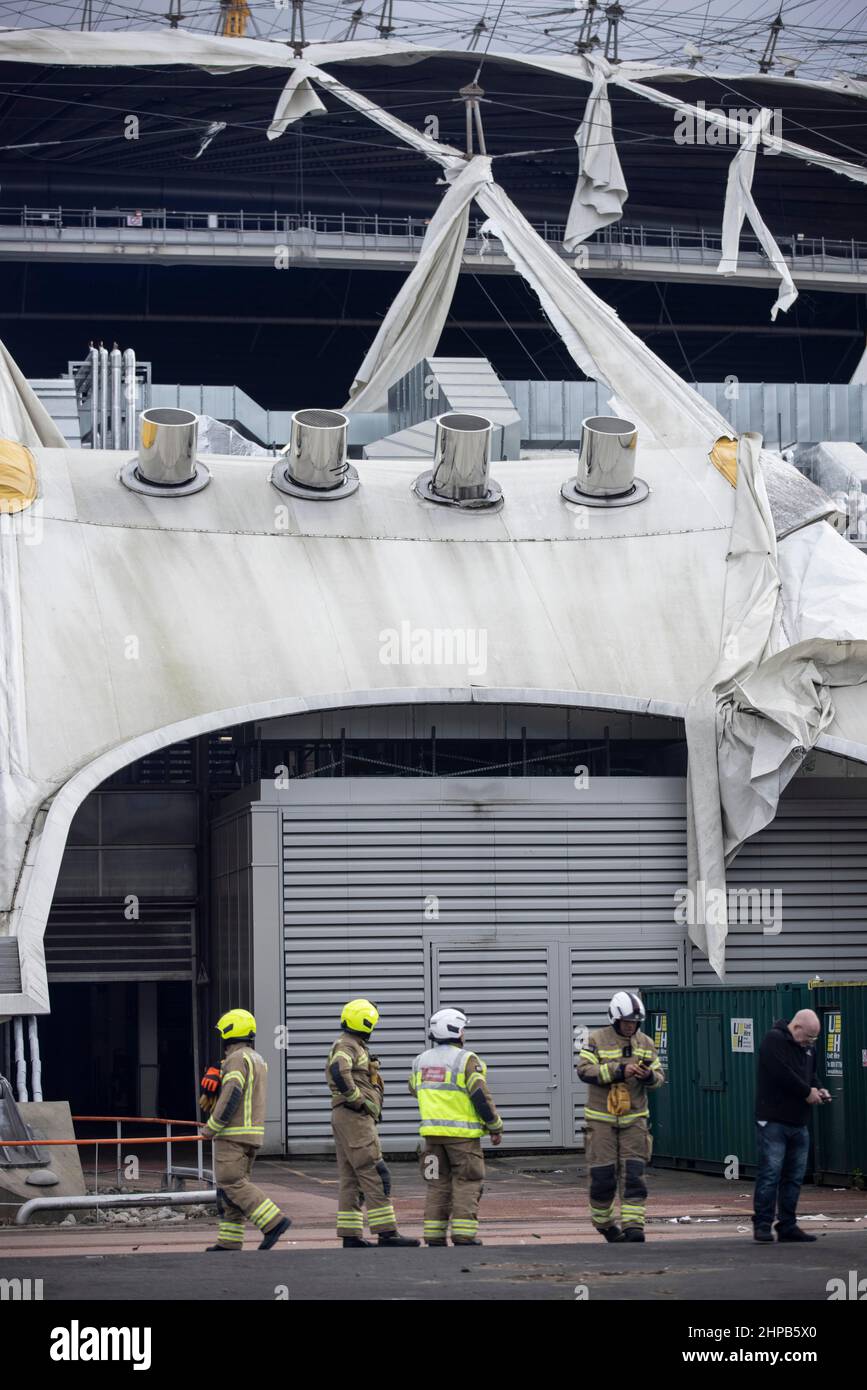 Fireman attend the scene at O2 Arena in East London where the tarpaulin was ripped due to high winds caused by Storm Eunice on Friday 18th Feb 2022 Stock Photo