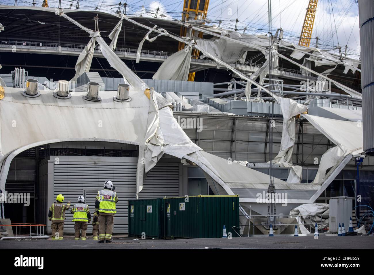 Fireman attend the scene at O2 Arena in East London where the tarpaulin was ripped due to high winds caused by Storm Eunice on Friday 18th Feb 2022 Stock Photo