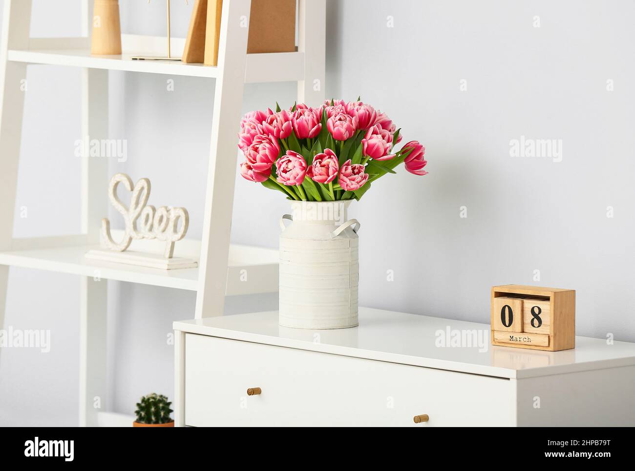 Beautiful bouquet of fresh flowers with calendar on chest