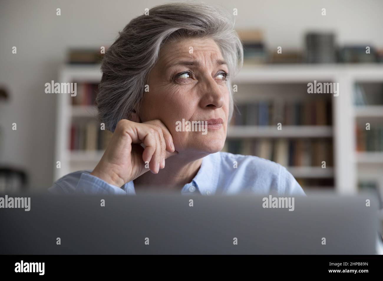 Head shot stressed middle aged businesswoman working on computer. Stock Photo