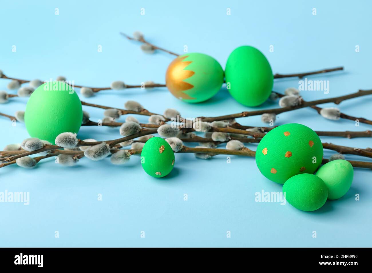 Painted Easter eggs and pussy willow branches on blue background Stock ...