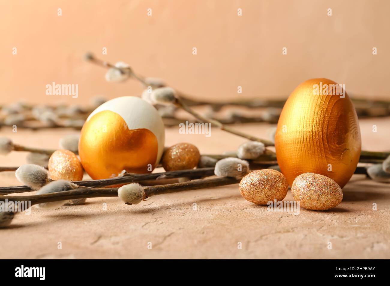 Painted Easter eggs and pussy willow branches on color background Stock ...