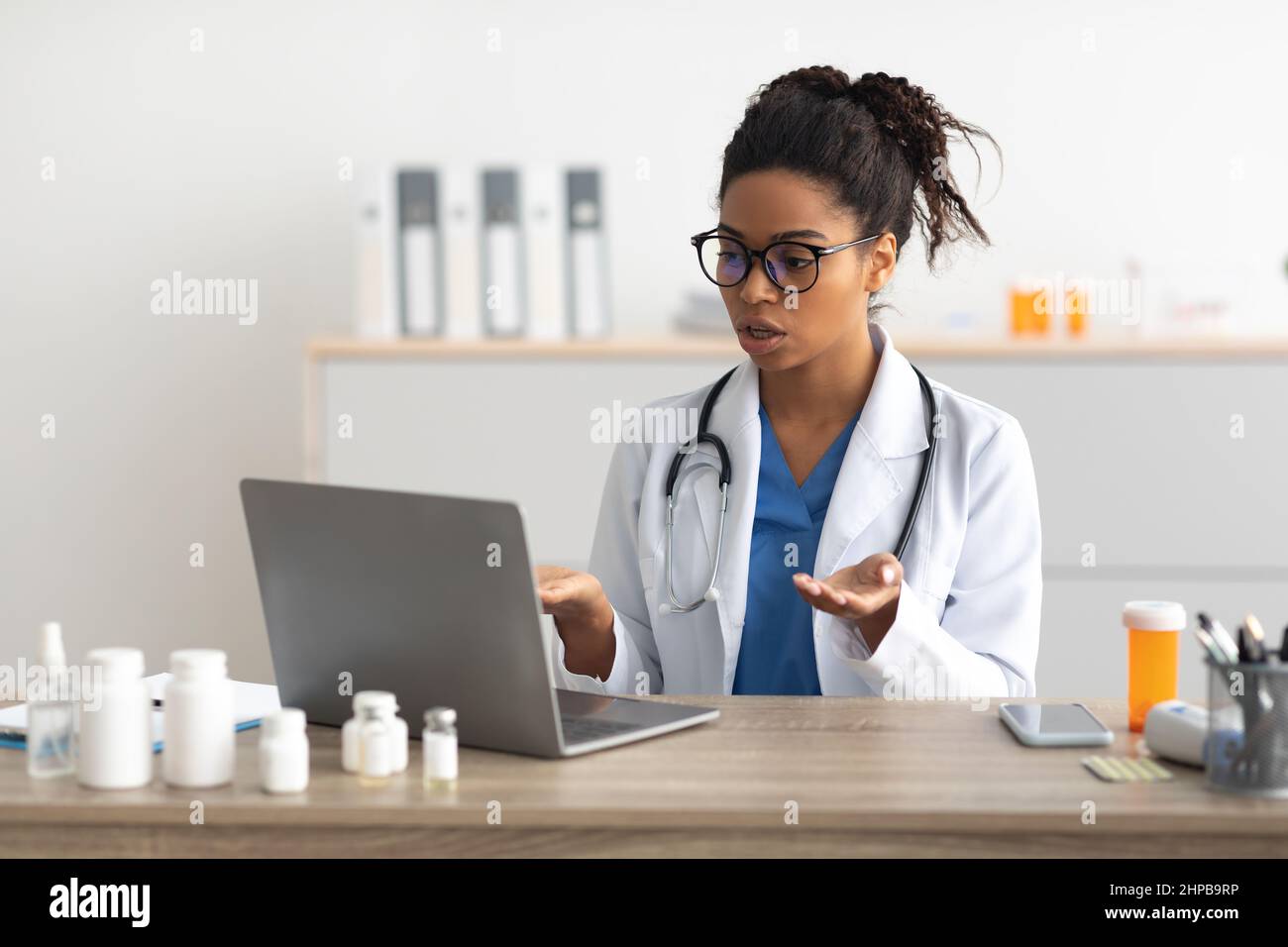Portrait of black female medical practitioner using laptop Stock Photo
