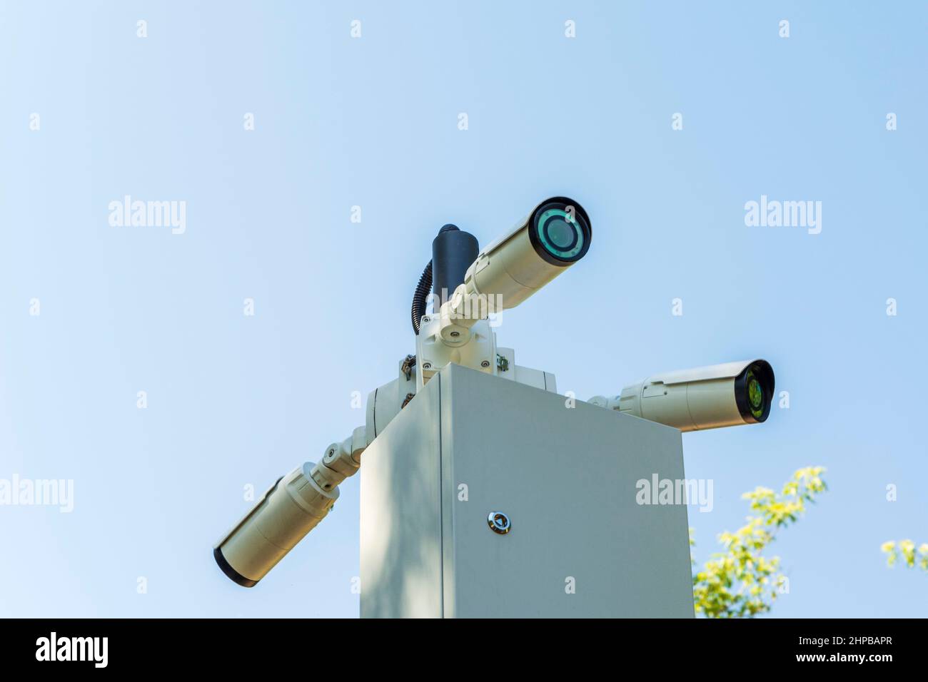 Security cameras and a WiFi station installed on a pole in a public place. Surveillance and