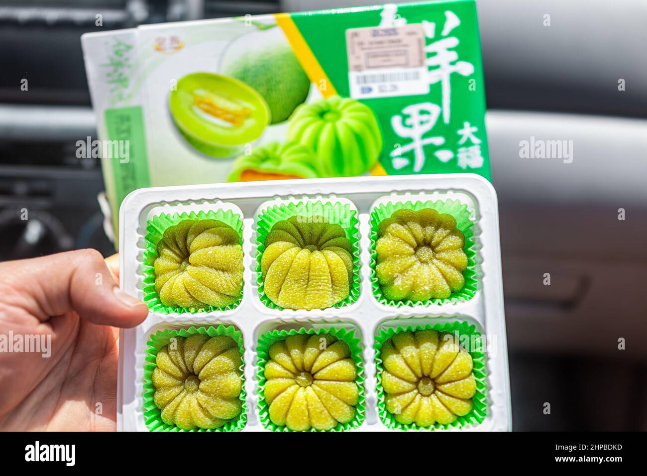 Naples, USA - August 5, 2021: Closeup of storebought at Ross hami melon filled mochi rice cake Japanese dessert by Royal Family brand with package lab Stock Photo