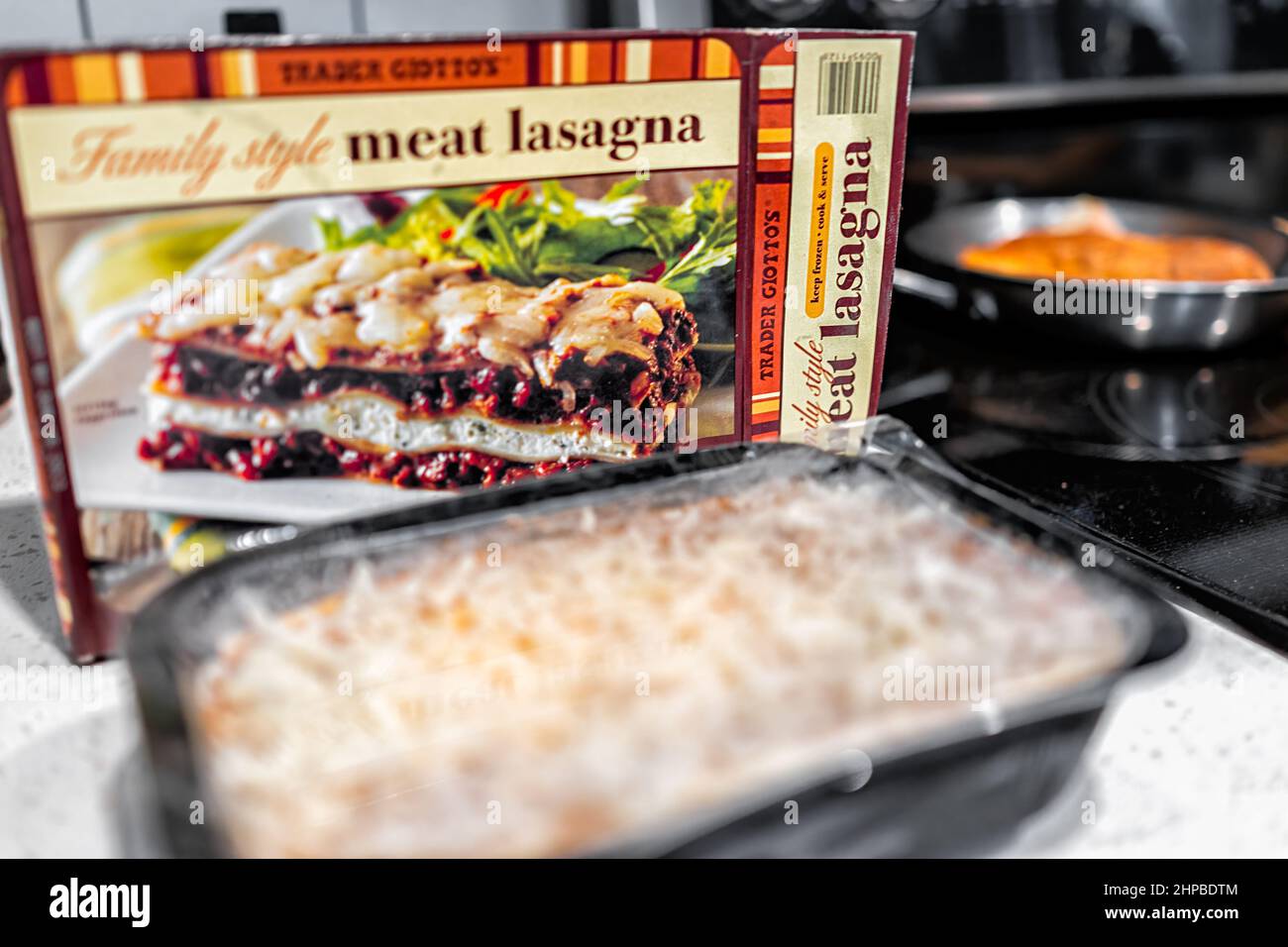 Naples, USA - August 28, 2021: Trader Joe's Italian Family Style Meat Lasagna package with frozen tv dinner tray for oven baking Stock Photo