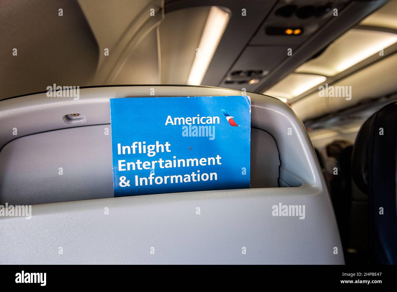 Washington DC, USA - August 25, 2021: Airplane plane seat point of view in American Airlines flight with inflight entertainment information booklet bl Stock Photo