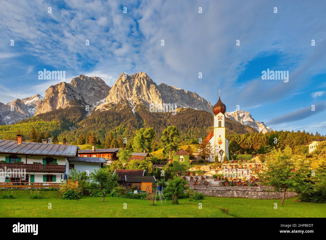 Zugspitze peak and Alps mountain range with small church, Garmisch Partenkirchen, Germany Stock Photo