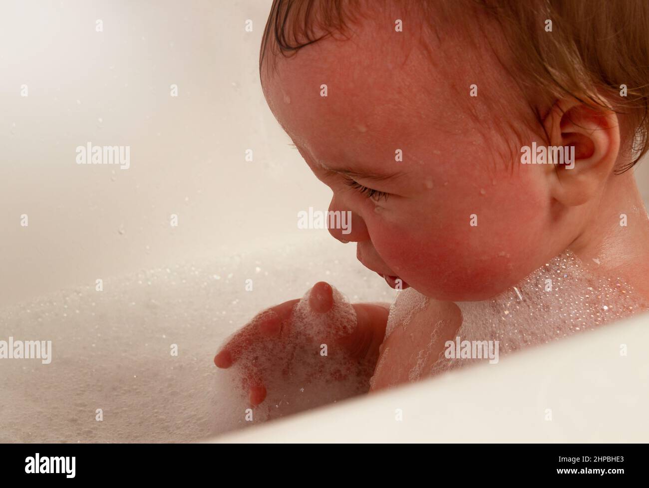 little girl takes a bath, cries and screams Stock Photo Alamy