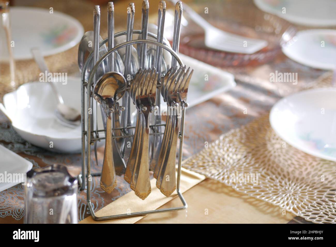 empty plate, table napkin with knife and fork on table. Stock Photo