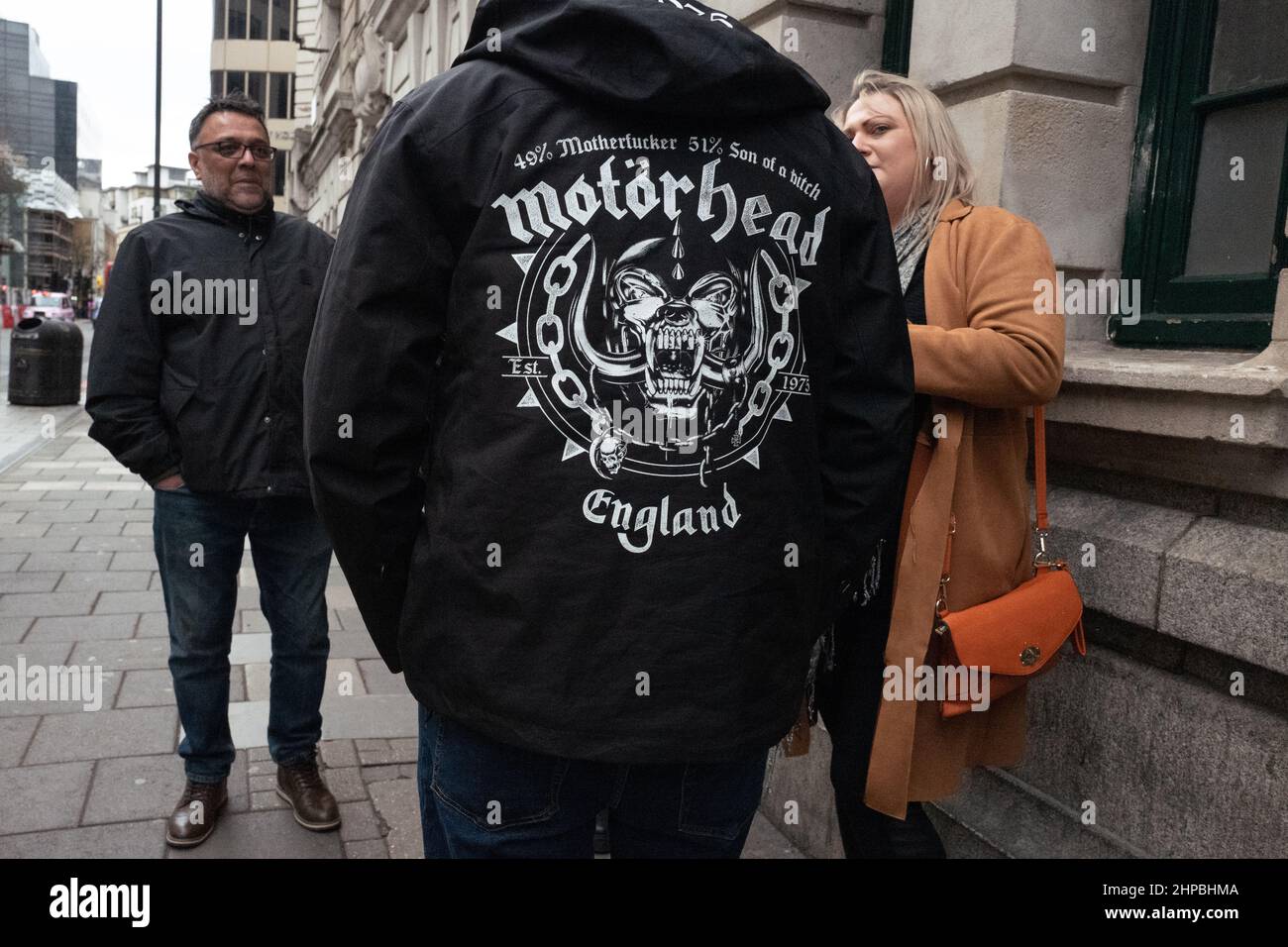 People chatting on a London street. The main element is Snaggletooth the emblem of Heavy Rock band Motorhead. Stock Photo