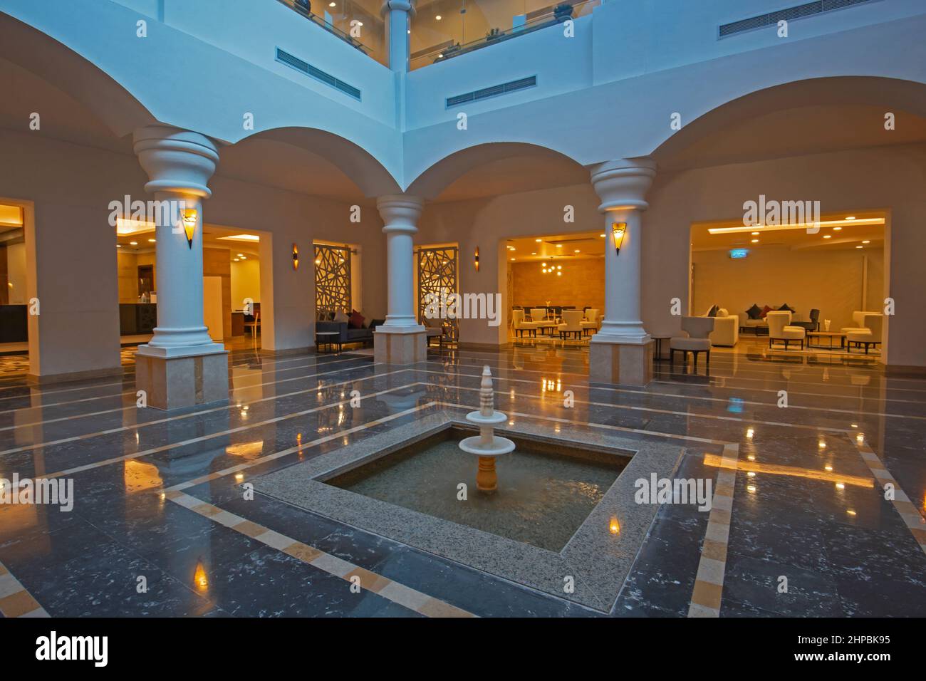 Interior design of a luxury hotel resort lobby reception area with seating and columns Stock Photo