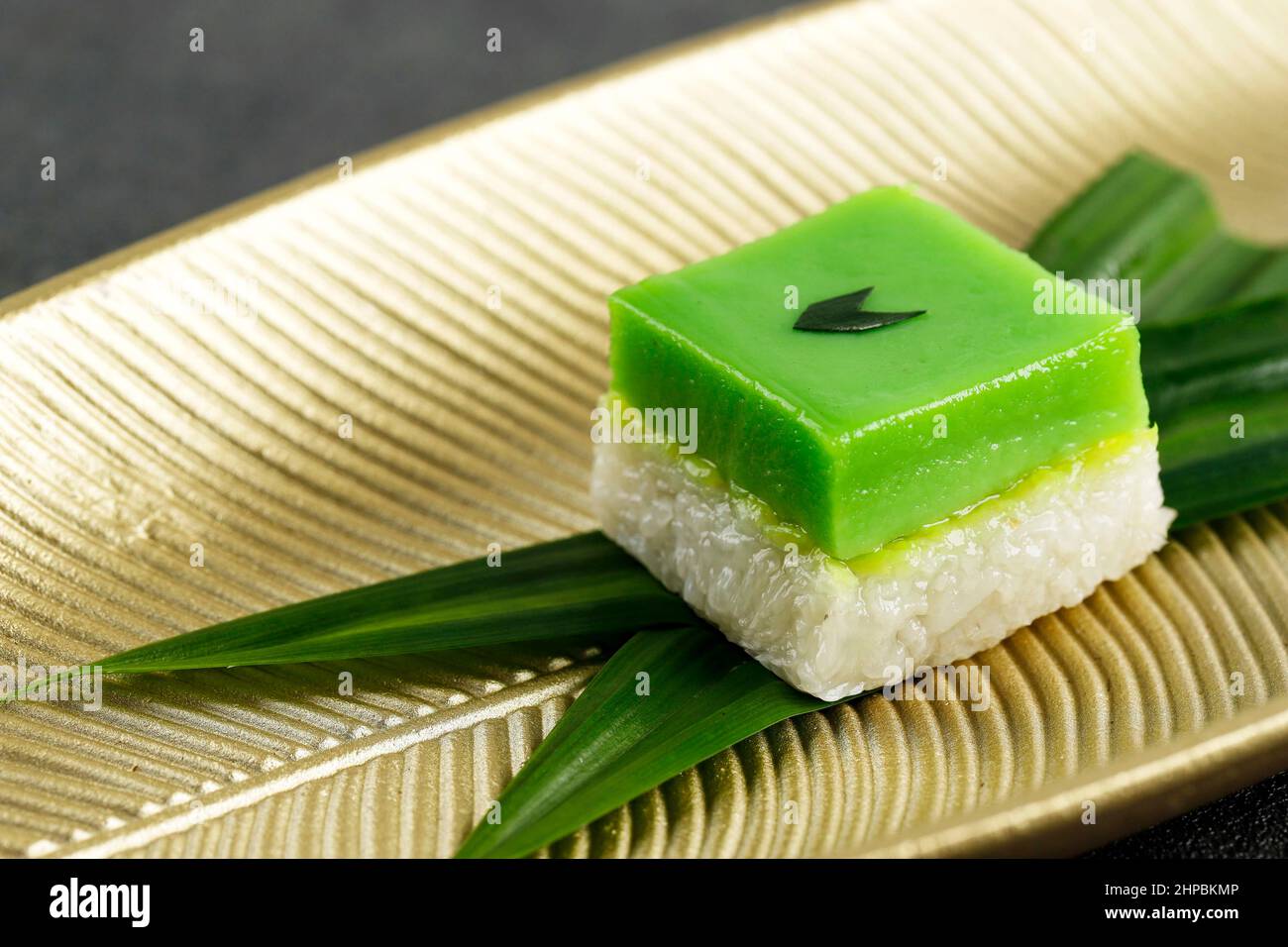 Talam Ketan or Kuih Seri Muka,  Two Layered Dessert with Steamed Glutinous Rice at the Bottom and Green Custard Layer Cake on Top. Stock Photo