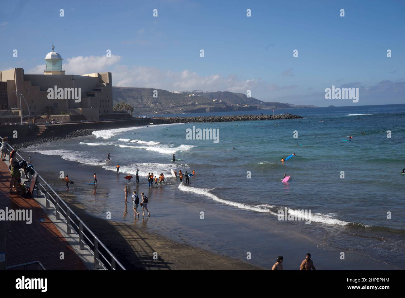 Young people and children surfing in Las Canteras beach in Las Palmas