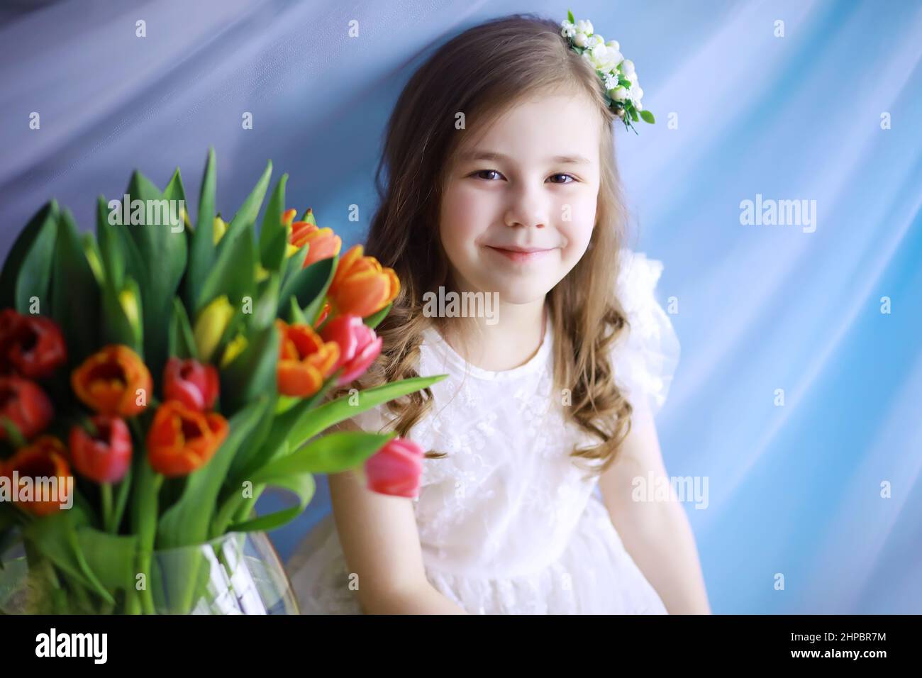 Beautiful girl in white dresses with a magnificent bouquet of first ...