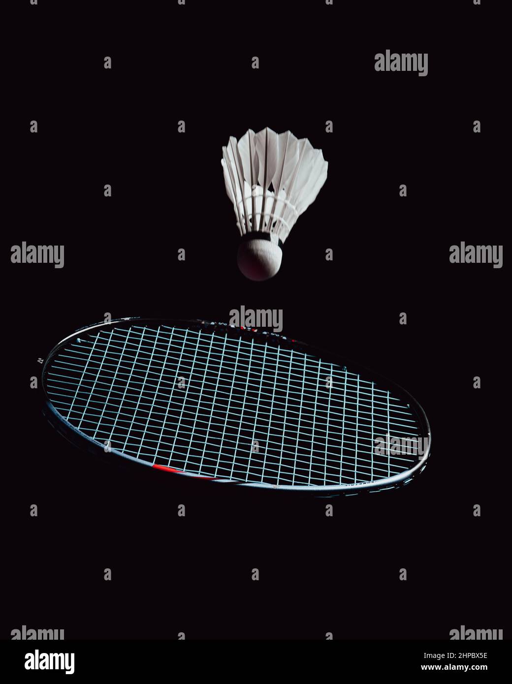 Racket and a birdie on a black background Stock Photo - Alamy