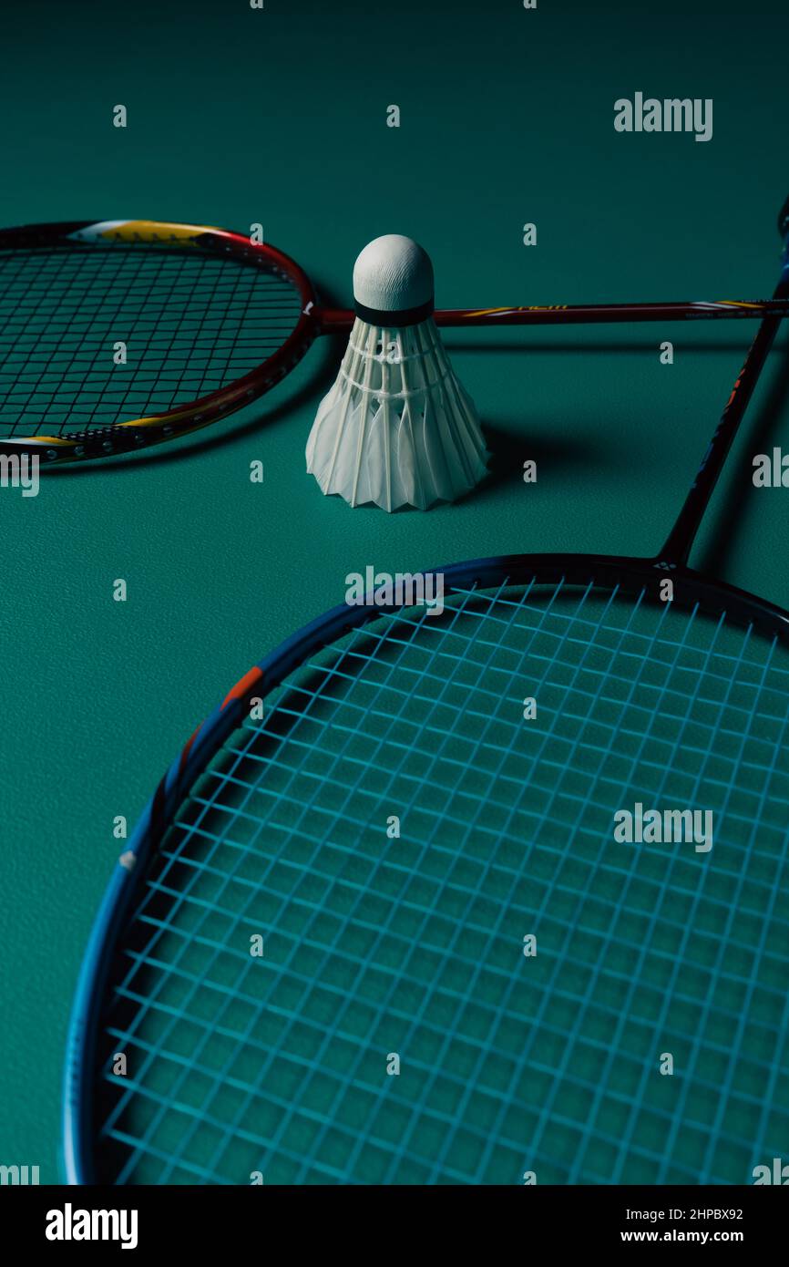 Pair of racket and a birdie on a green badminton court Stock Photo Alamy