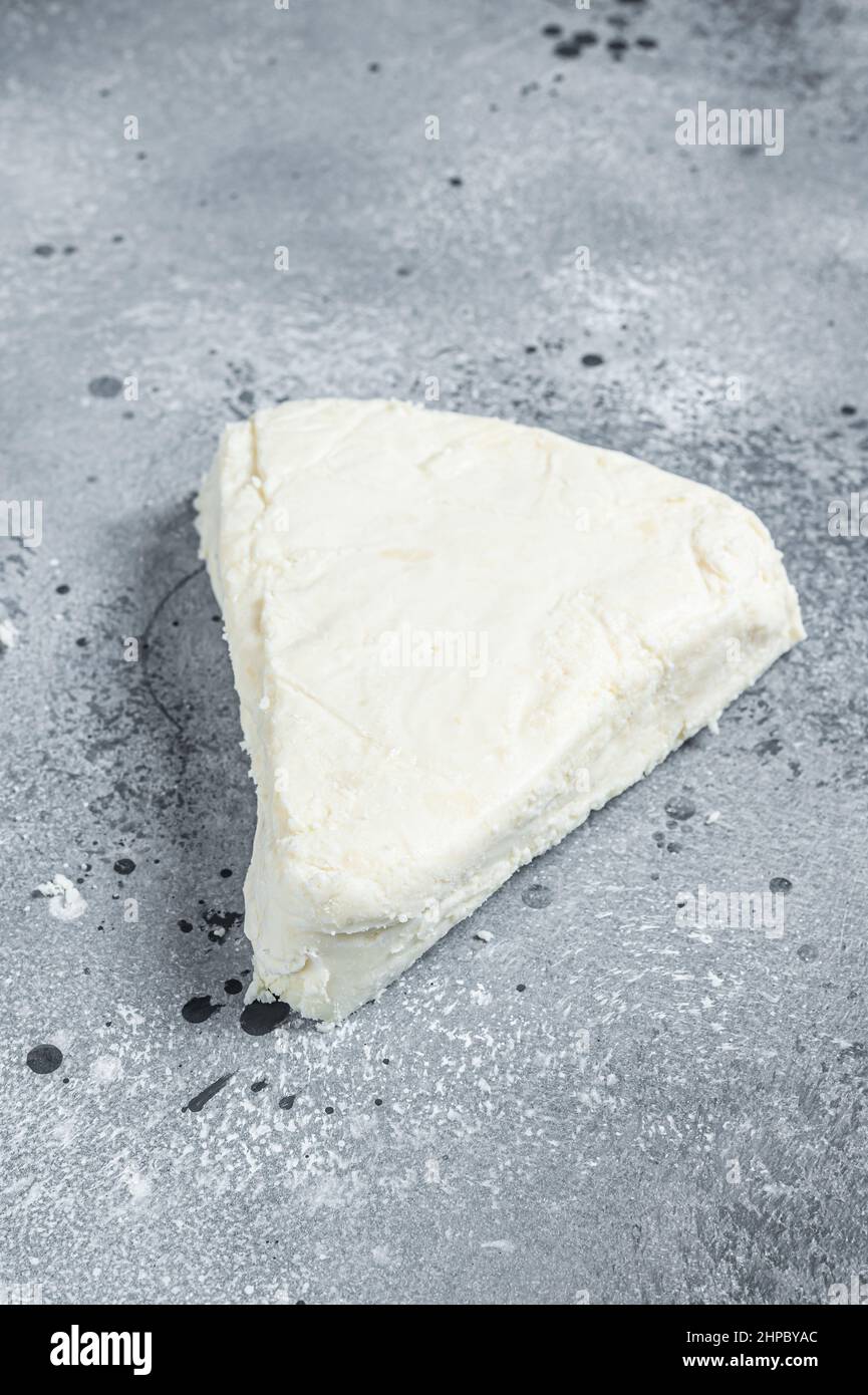 Soft goat and sheep milk cheese. Gray background. Top view Stock Photo