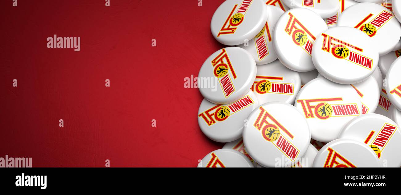 Logos of the German Soccer Club FC Union Berlin on a heap on a table. Copy space. Web banner format Stock Photo