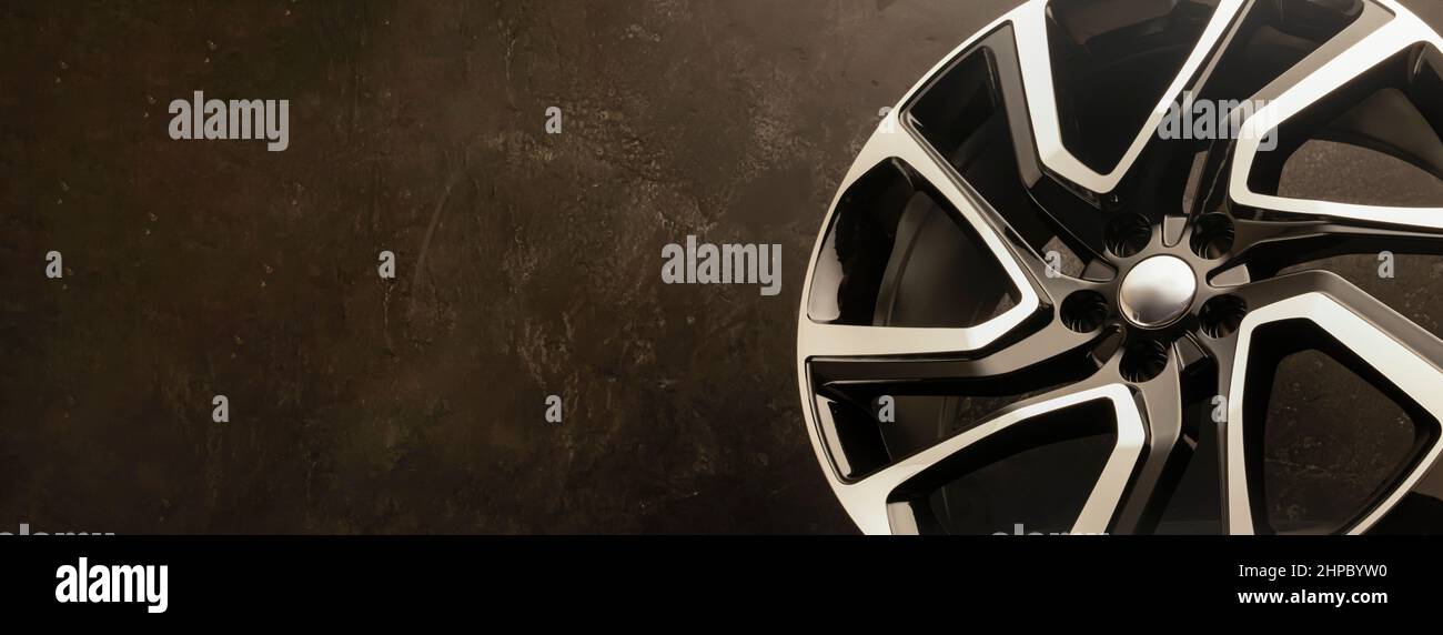 new stylish cool alloy wheel on the tire dark textured background,  beautiful and expensive 20 -21, 22 ,large diameter copyspace on the left,  fragment Stock Photo - Alamy