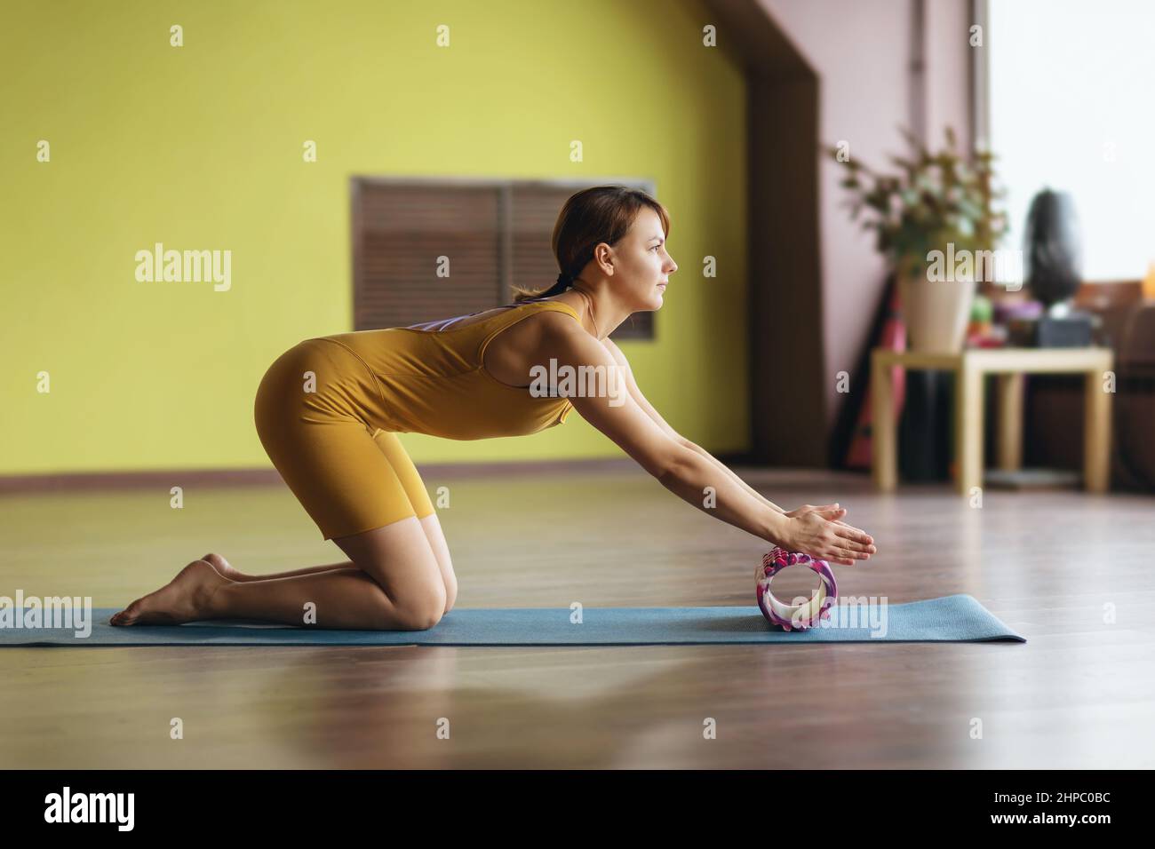Message Forearms A woman in sportswear performs myofascial massage of the muscles of the ...