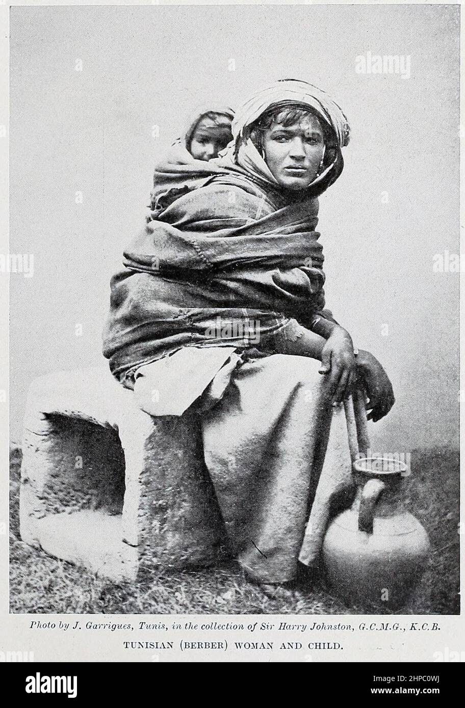 Tunisian (Berber) woman and child from the book ' The living races of mankind ' a popular illustrated account of the customs, habits, pursuits, feasts & ceremonies of the races of mankind throughout the world by Sir Harry Hamilton Johnston, and Henry Neville Hutchinson Published in London by Hutchinson & Co. in 1902 Stock Photo