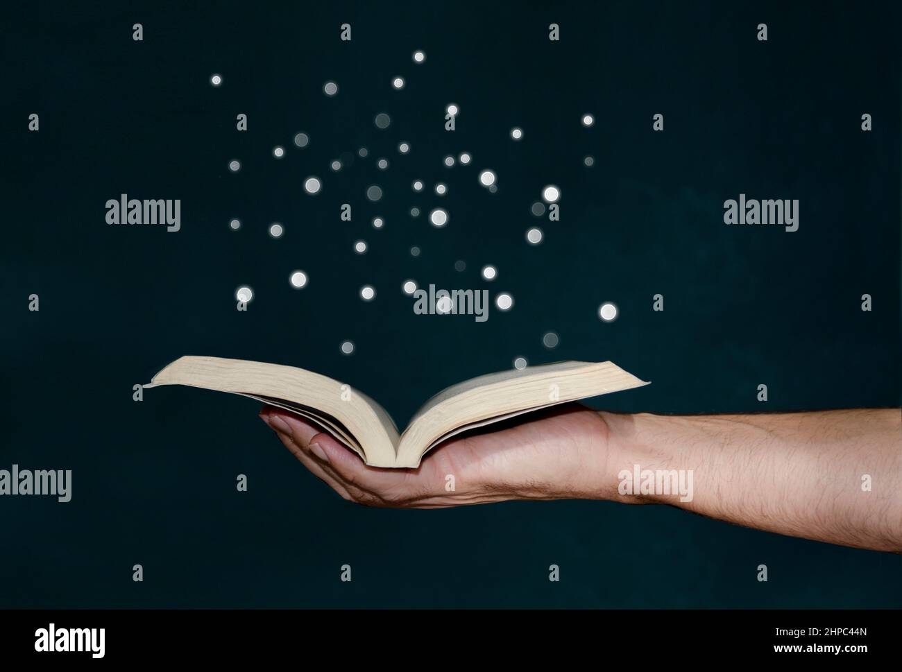 Man holding magic book with hand Stock Photo