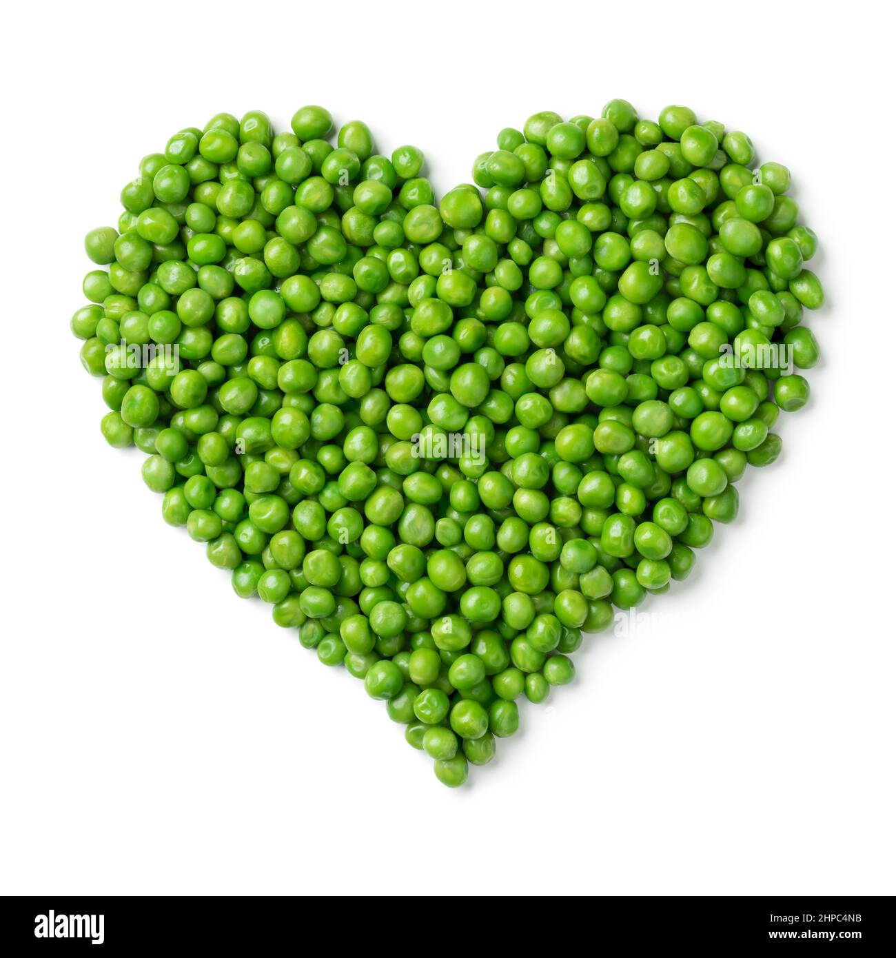 Fresh green peas in heart shape isolated on white background Stock