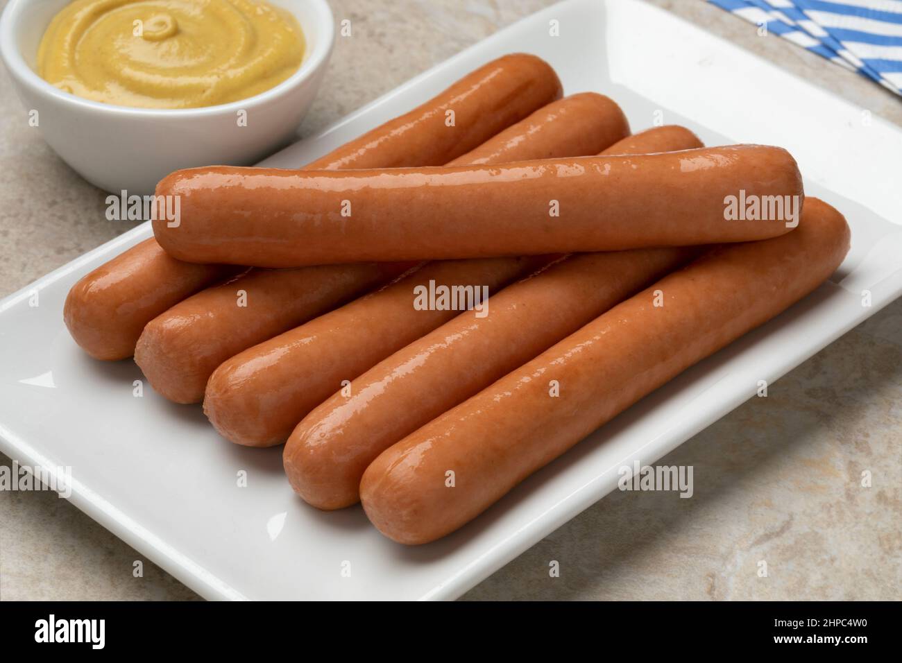 Dish with Frankfurter sausage close up for a snack with a bowl of mustard Stock Photo