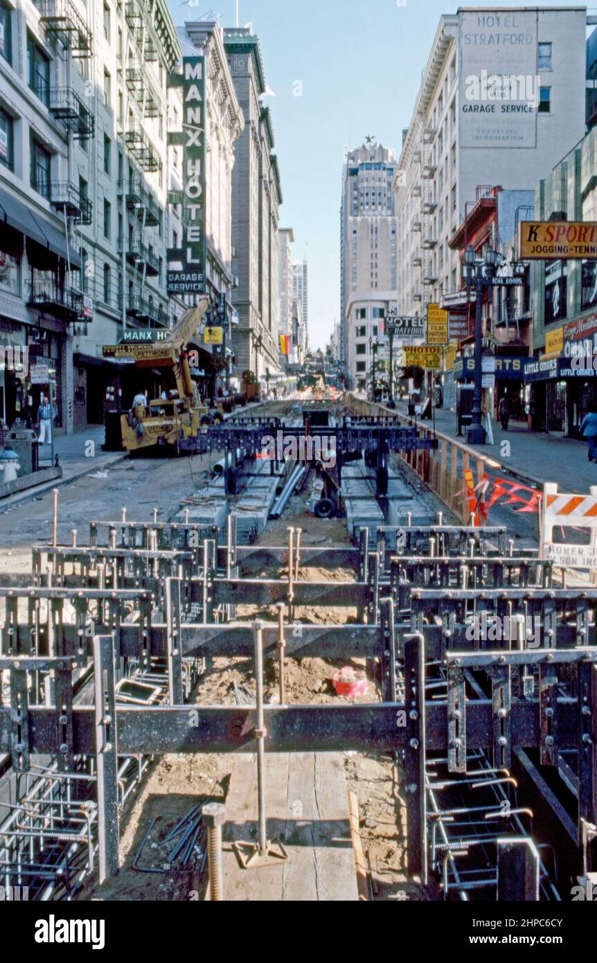 Construction workers relaying the cable car tracks in Powell Street, San Francisco, California, USA in 1980 – in this view looking northwards uphill from south of Union Square. The Powell Street cable car lines were originally built by the Ferries & Cliff House Railway Company, which started construction in 1887 after winning several franchises for cable car operation – a vintage 1980s photograph. Stock Photo