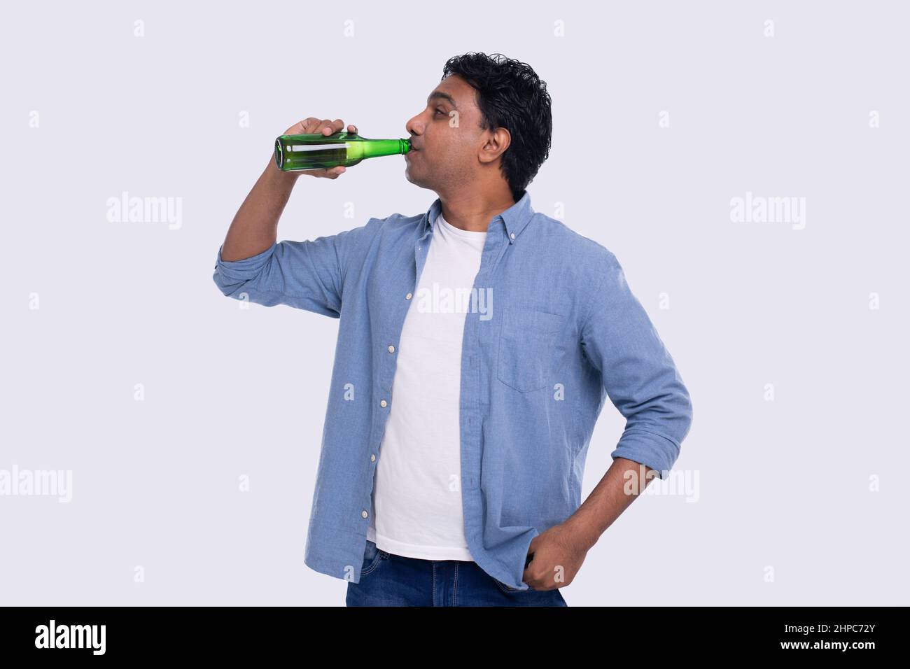 Indian Man Drinking Beer from Glass Beer Bottle. Indian Man with Drink
