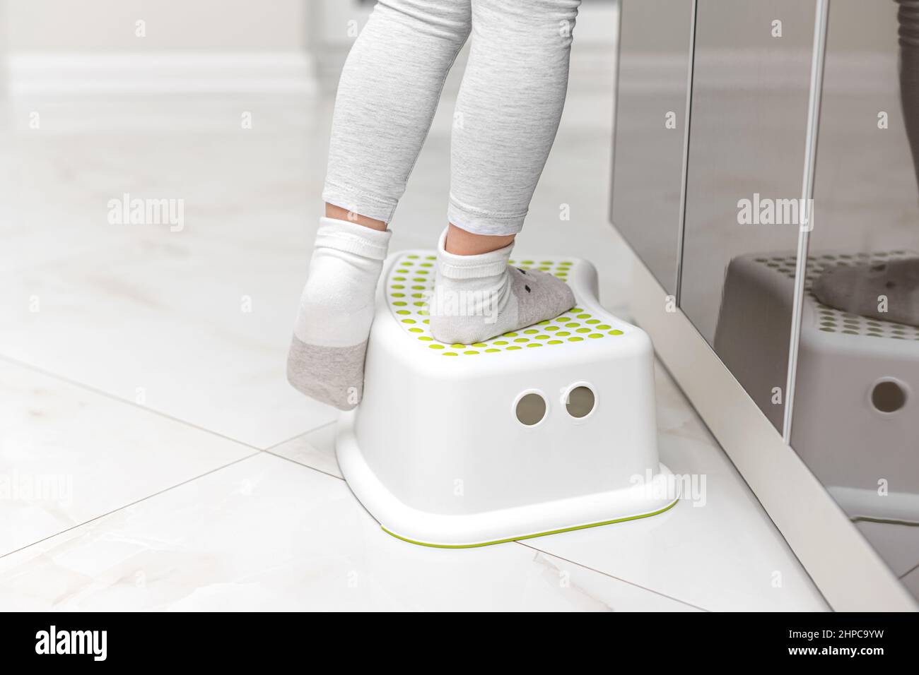 Small feet stand on a stand for children Stock Photo