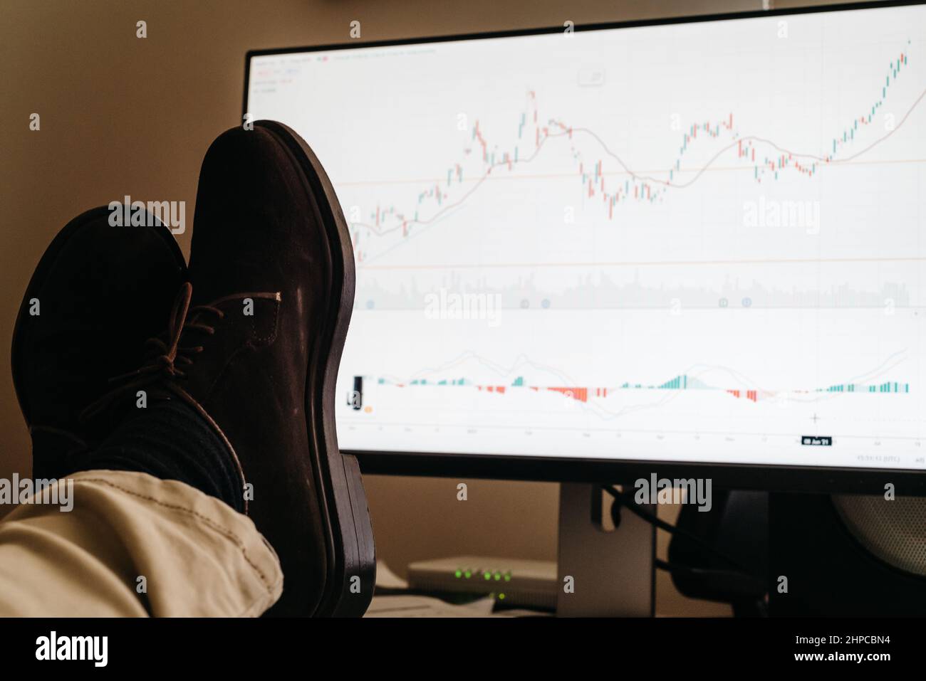 View of the broker feet on the trading desk in front of the stock