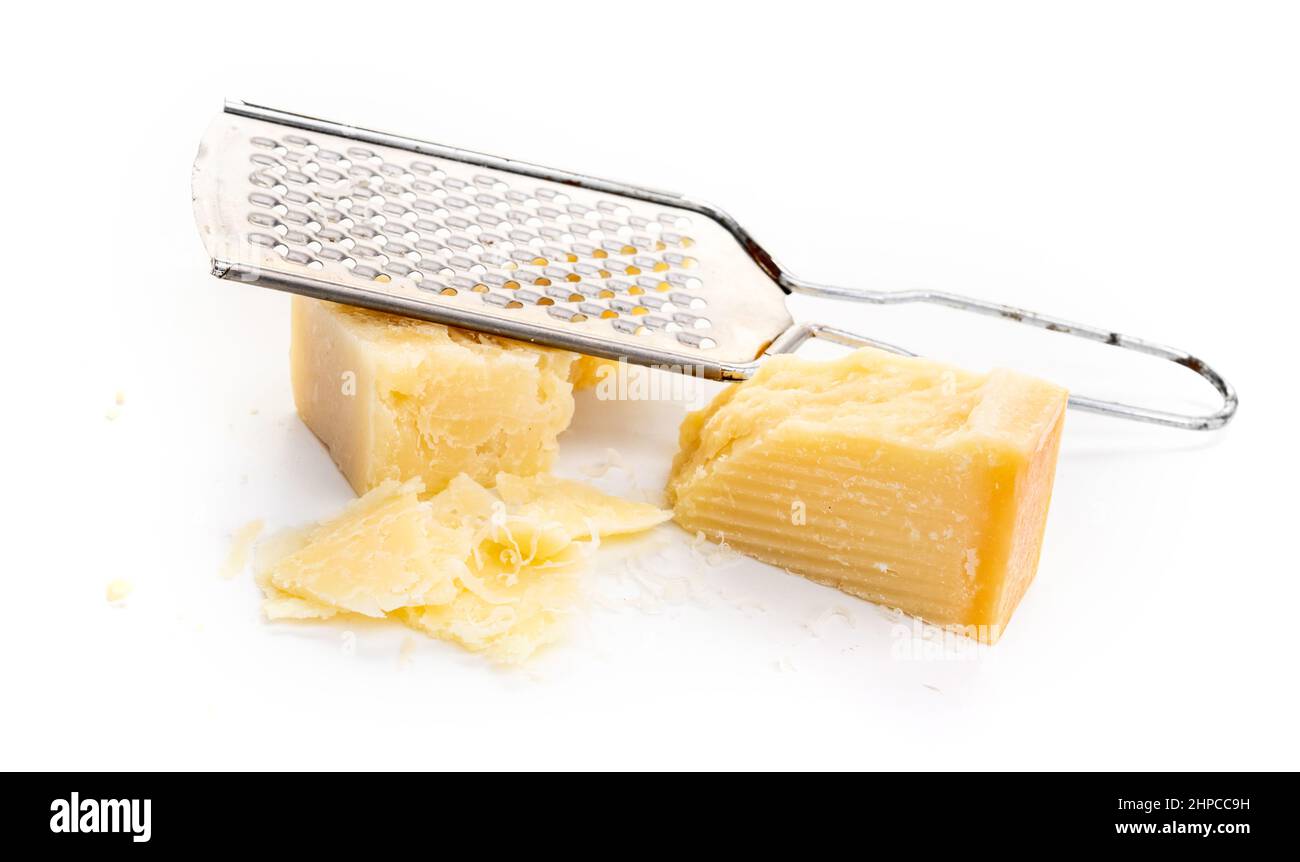 Piece of parmesan cheese and grater on white background Stock Photo Alamy