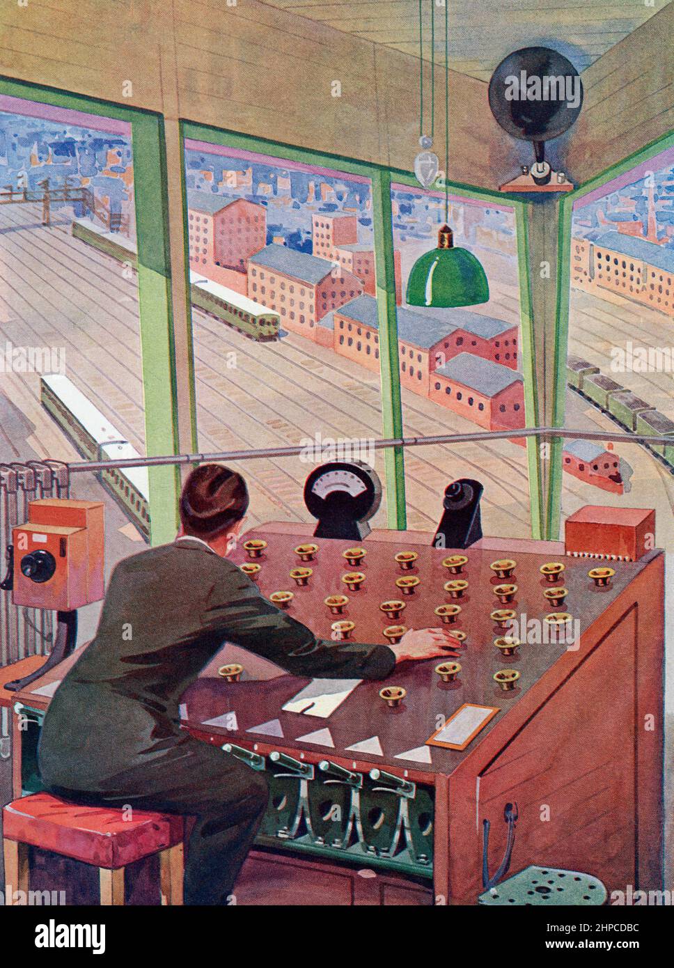 A robot signalman.  The operator in this control cabin could deal with 2,000 wagons in twenty four hours. By pressing various buttons on the board he could break and shunt wagons into any of the fifty sidings.  From The Wonder Book of Science, published 1930's. Stock Photo
