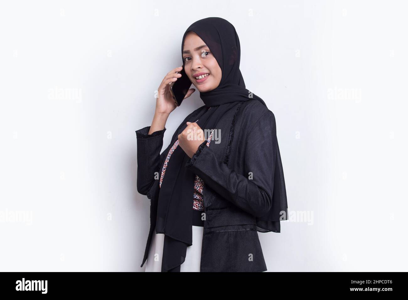 happy young asian beautiful muslim woman using mobile phone isolated on ...