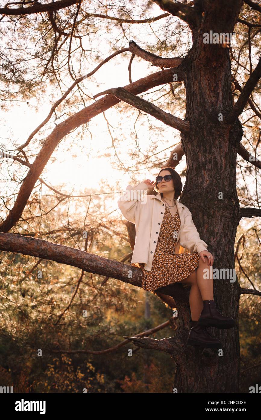 Woman sitting young branch hi-res stock photography and images - Alamy