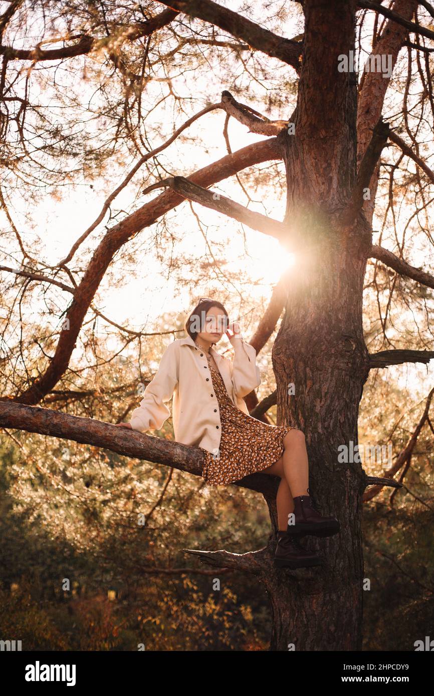 Woman sitting young branch hi-res stock photography and images - Alamy