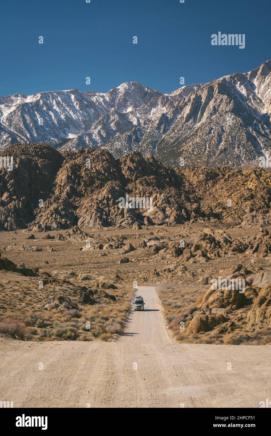 Van driving on Movie Road in The Alabama Hills Stock Photo