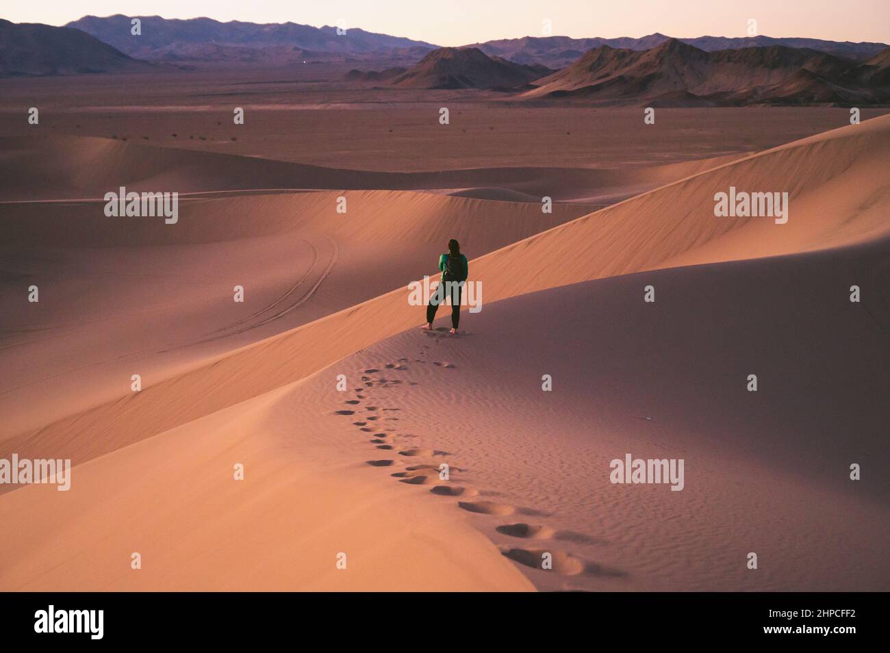 Female posing on a sand dune at sunset Stock Photo - Alamy