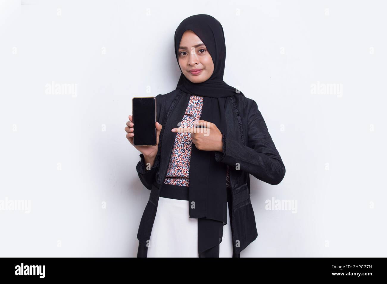 Happy Asian woman in hijab demonstrating mobile cell phone. Portrait of ...