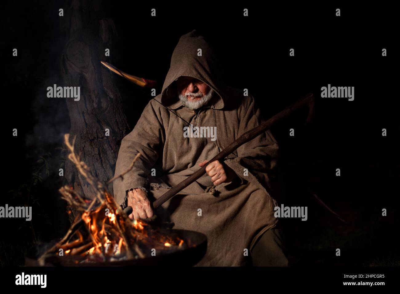 Old man in the middle ages with a bow and arrow Stock Photo