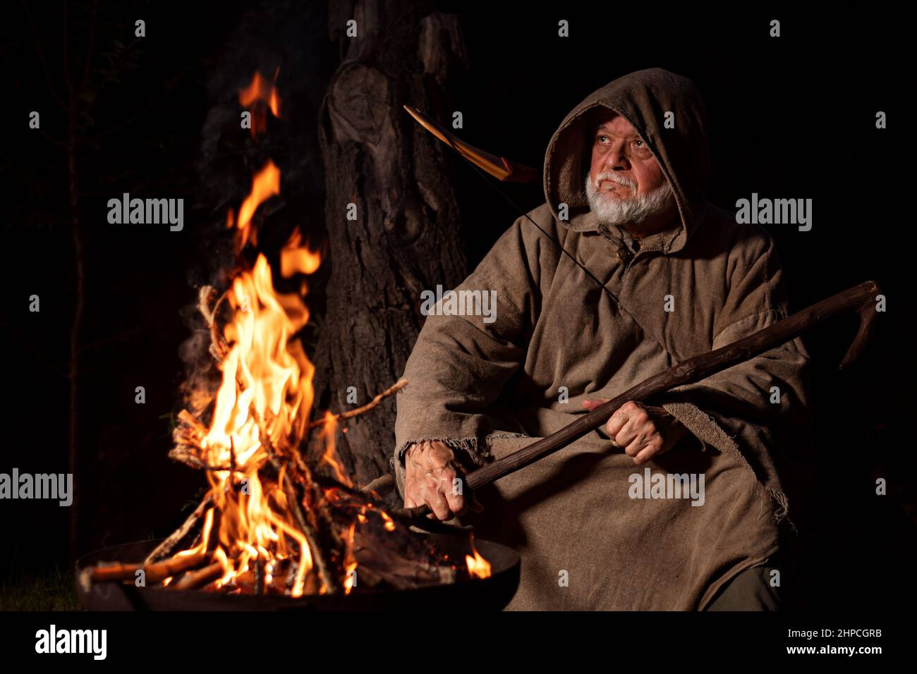 Old medieval fighter around the campfire Stock Photo