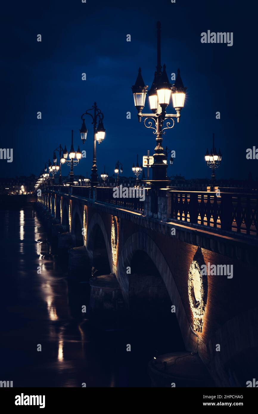 Famous stone bridge in Bordeaux by night, France Stock Photo