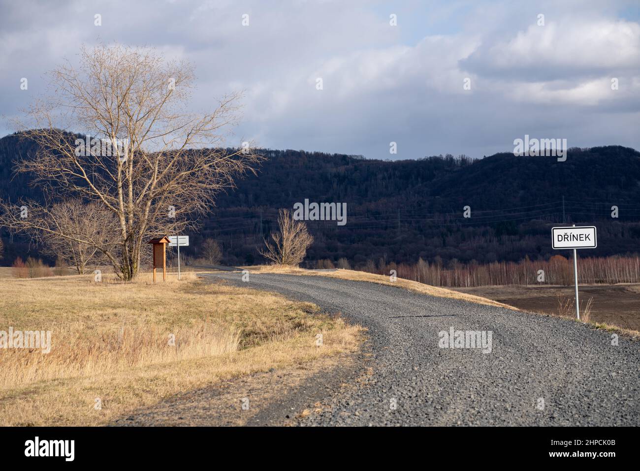 Radovesice dump, recultivated remnant of coal strip mining. Signs reminding of Dřínov village destroyed to make place for the dump. Stock Photo
