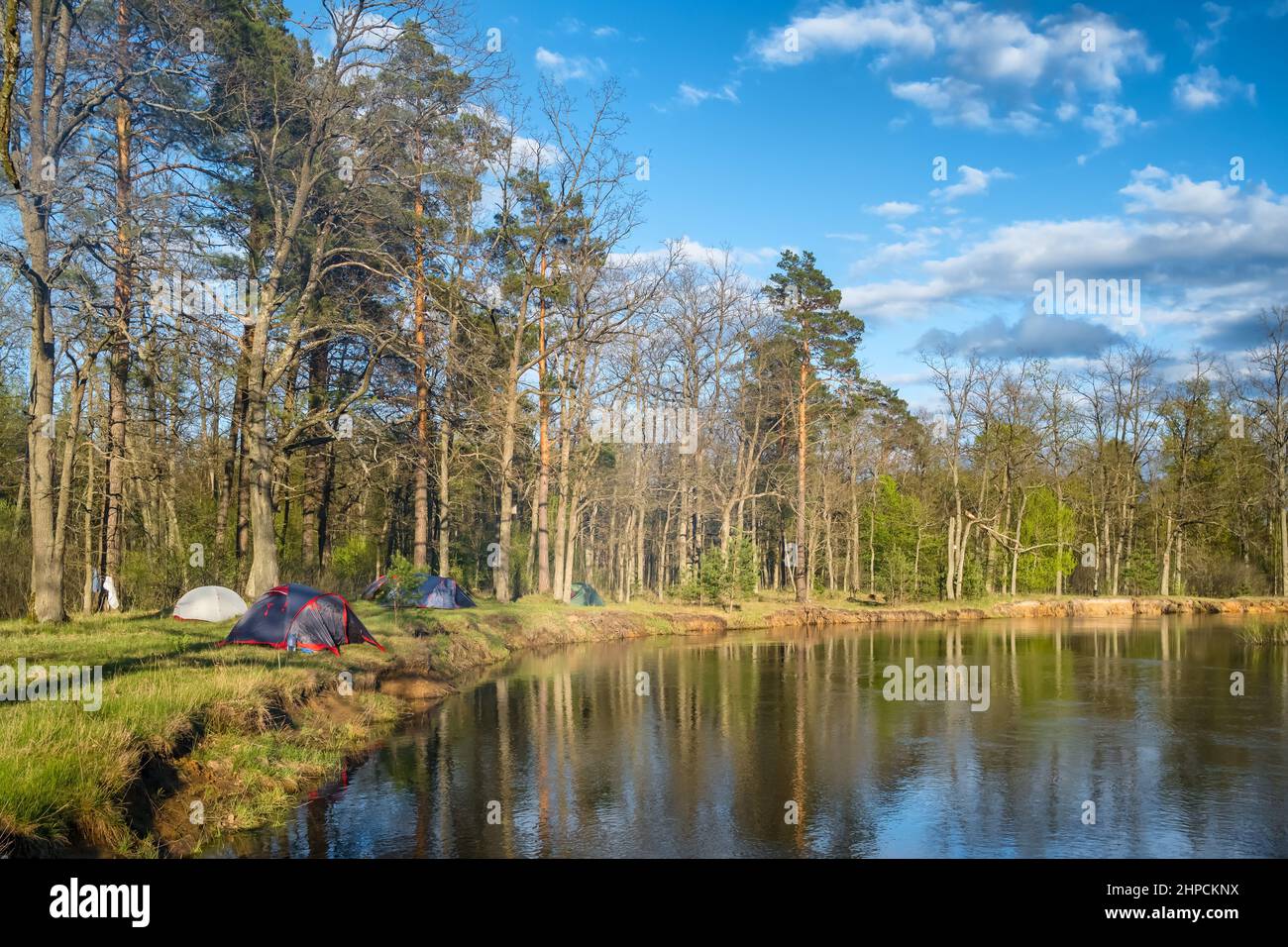 Wild camping on the river shore in early spring Stock Photo
